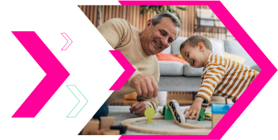 Man and his grandson playing with model trains